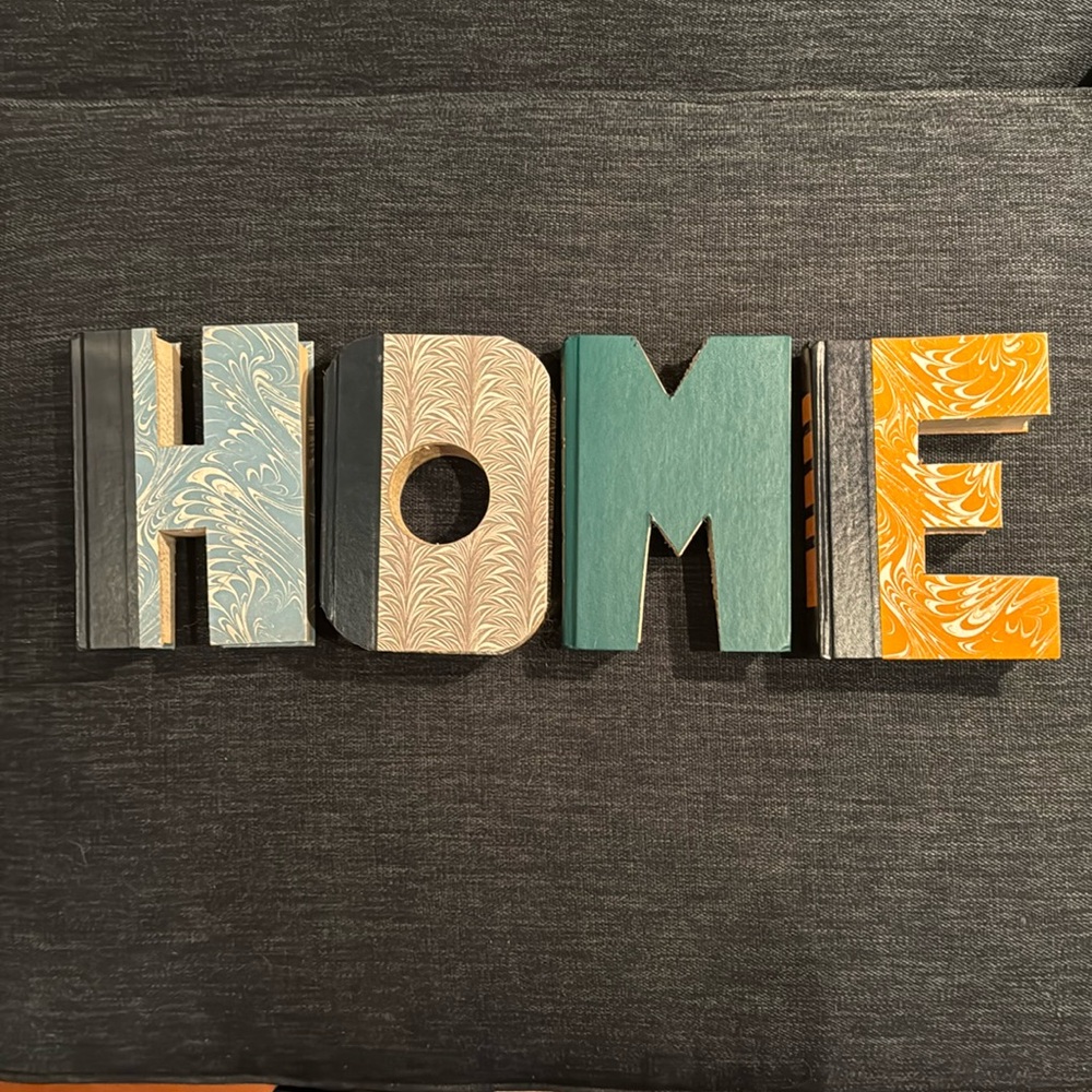 Anthropologie: Hand cut letters from Reader’s Digest books. Spells out “HOME.”